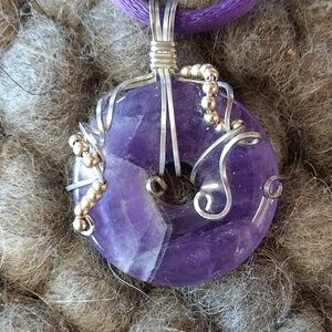 Amethyst donut pendent with wire decoration on cord